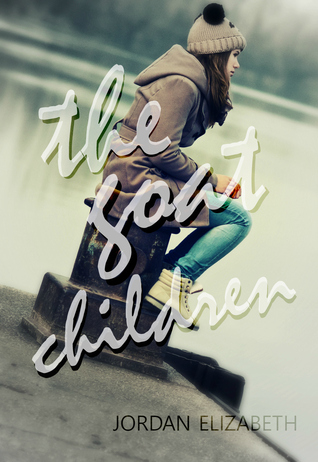 Lonely teenage girl sitting on the dock on cold winter day.